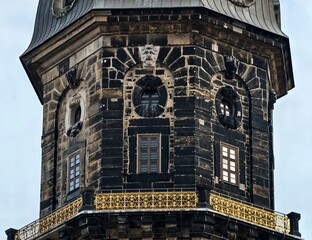 Decorative historic timepiece structure. Weathered monument featuring intricate balcony details © Vladimir
