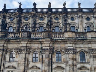 Facade of structure exhibiting historic architectural features and textured stone workmanship across surface © Vladimir