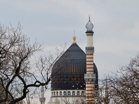 Ancient religious site showcasing patterned tiles and classical architecture elements during gray winter days