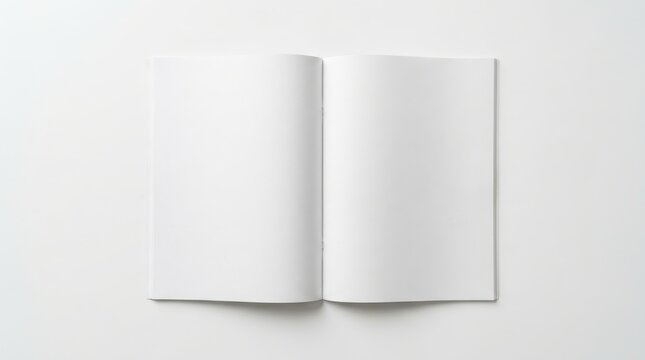 An open blank book with clean white pages lies flat on a white surface, creating a minimalist and clean aesthetic with ample copy space.