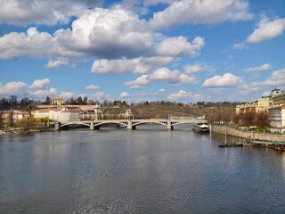 Obraz premium Scenic river view with bridge and boats. Vivid sunny river scene featuring bridge and relaxing boat