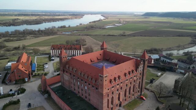 Gniew - Polska - stare miasto z pięknym kościołem i zamkiem krzyżackim nagrane dronem w słoneczny dzień