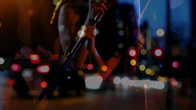 Female singer gripping mic, leaning, singing emotively for music club crowd with city bokeh overlay