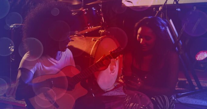 Guitarist starting chords, singer leaning into mic and singing during music session gels sweeping