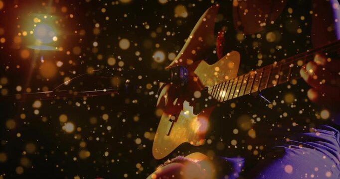 Camera revealing woman with guitar, hands forming chords and strumming for music, golden bokeh veil