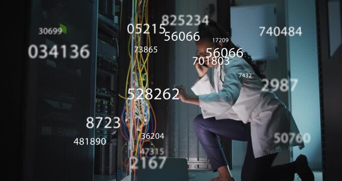 Woman tech kneeling at rack, causing data overlay tracing network cables during checks, on phone