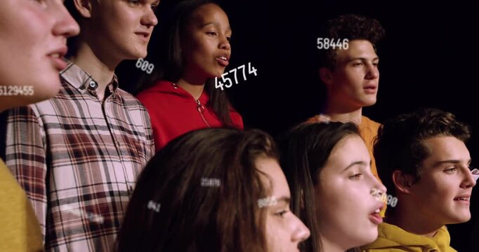 Teen choir singing, camera panning showing singers, numbers drifting across faces for music