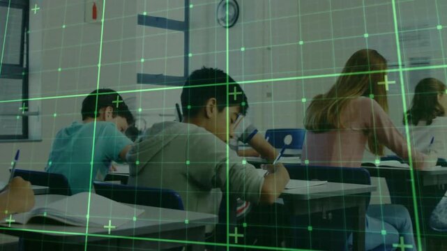 Students writing test at desks in classroom, camera pulling back while green HUD grid scanning