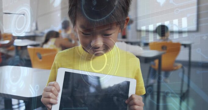 Male child raising head in class after gripping tablet, HUD over screen while seeking eye contact