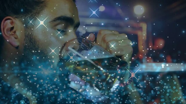 Man gripping, tilting beer mug at bar, drinking to relax with sparkles highlighting foam reflection