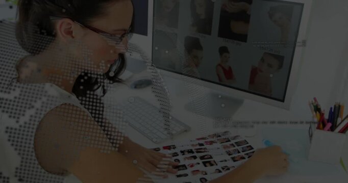 Woman examining proof sheet, touching monitor, selecting headshots for ad, dotted overlay sweeping