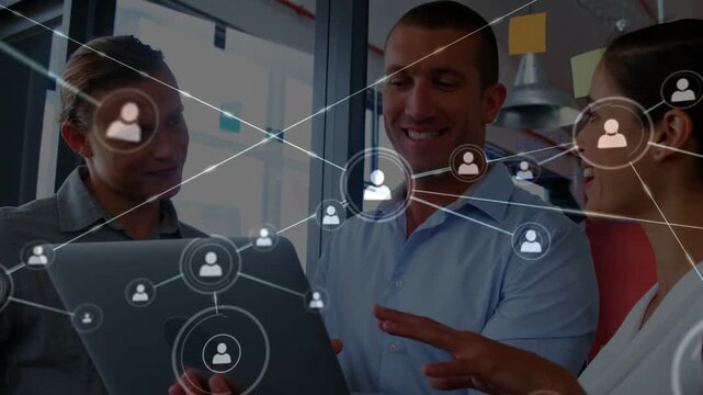 Team gathering by laptop discussing business while network expanding from screen syncing gestures