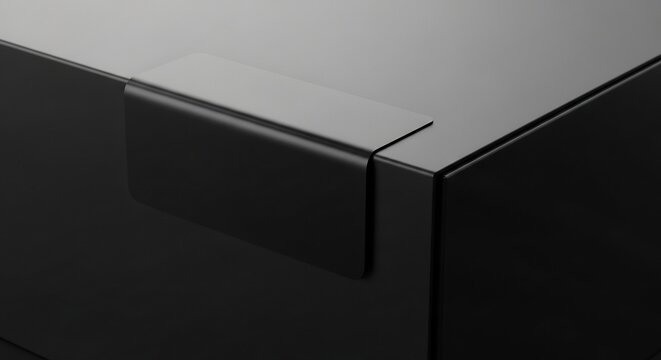 Close-up of a sleek black modern furniture corner detail.