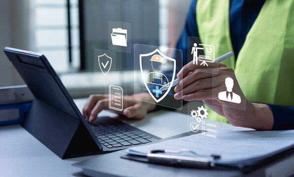 Safety specialist using laptop with digital protection icons, workplace compliance monitoring, risk prevention strategy and occupational health management system concept.
