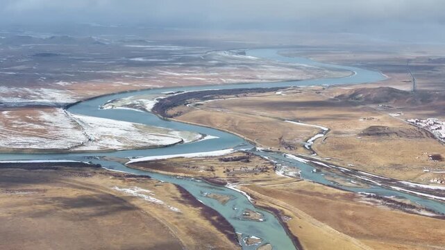 Aerial view of the First Bend of the Yellow River in Zoige, winter landscape of meandering river and frozen wetlands on the Tibetan Plateau