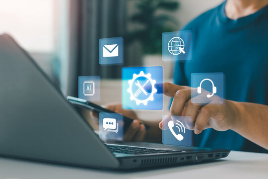 Business technology concept. Digital technical support and customer service management via laptop and smartphone with virtual icons, AI automation, communication, helpdesk, online service solutions.