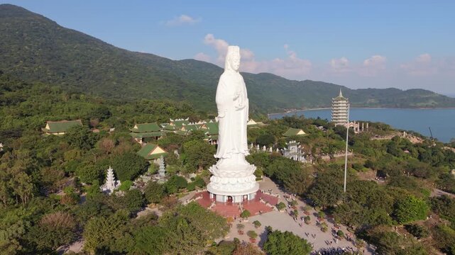 Panoramic Shrine View With Statue And Pagoda Tower Overlooking Coastline, Terraces And Temple Roofs Framed By Blue Sea And Green Hills At Son Tra, Da Nang, Vietnam, Sunny Sightseeing Mood