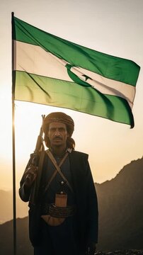 Middle Eastern Tribal Warrior Guarding Mountain Pass with Flag and Rifle