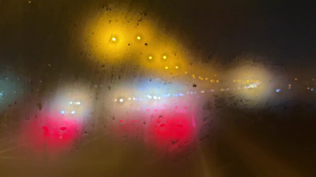 View from a fogged car window at rainy night in Istanbul, Turkey. (4K video)