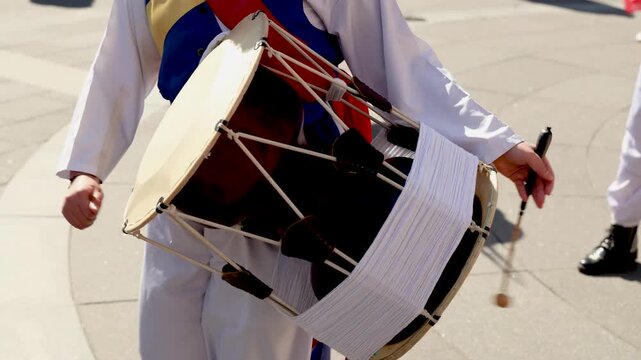 Close up of Korean Traditional Folk Performer Playing Janggu Drum in Jongno Seoul South Korea