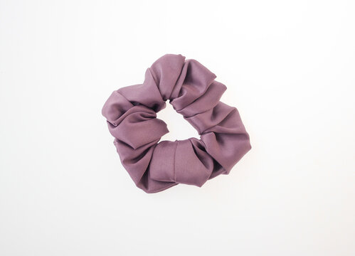stylish purple scrunchie trendy hair accessory for all hair types, hair scrunchie, accessory, trendy scrunchie, fashionable hair tie, soft fabric scrunchie, elastic material isolated white background