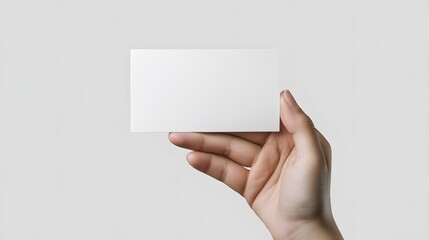Obraz premium Closeup of a hand holding a blank business card.