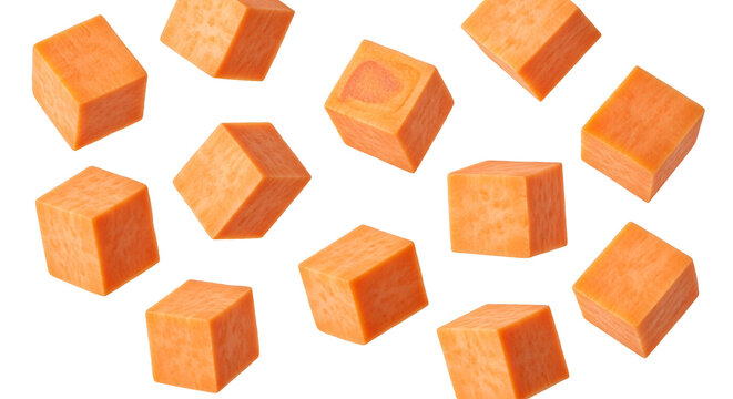 Scattered sweet potato cubes on white background