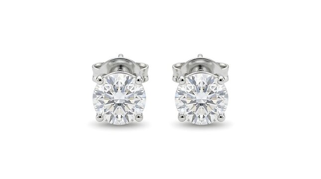 Pair of round brilliant cut diamond stud earrings with fourprong settings in white gold or platinum isolated on white background