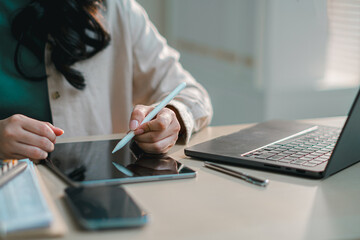 businesswoman using tablet on desk, representing digital finance, accounting, online banking, budgeting, tax management and workflow in office