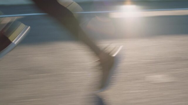 Running, fitness and person in city, legs and training for health benefits, shoes and lens flare. Outdoor, runner and athlete in street, exercise or sneakers for practice, challenge or cardio workout