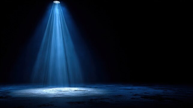 A single spotlight shining down on a dark stage