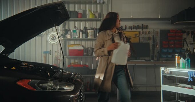 In Brightly Lit, Industrial Style Home workshop, Woman Performs Essential Vehicle Maintenance After Commute. Modern Garage Space, Featuring Digital Diagnostic Tools and Organized Hardware Within Reach