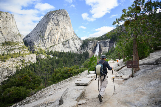 Man hiking John Muir trail towards Vernal Falls. Winter detour as Mist Trail is closed. Yosemite National Park. California. USA.