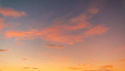 Fototapeta premium Beautiful Sunset Sky with Soft Clouds and Colorful Twilight Gradient,A breathtaking view of the evening sky during sunset, featuring a vibrant gradient of orange, yellow, and blue hues with scattered 