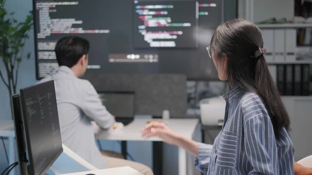 Programmer software engineer application developer working on coding programming indoor office workplace discussion teamwork brainstorming, business team concept