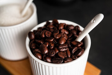 Fototapeta premium Coffee beans on a dark background. Coffee beans in cup. High quality photo