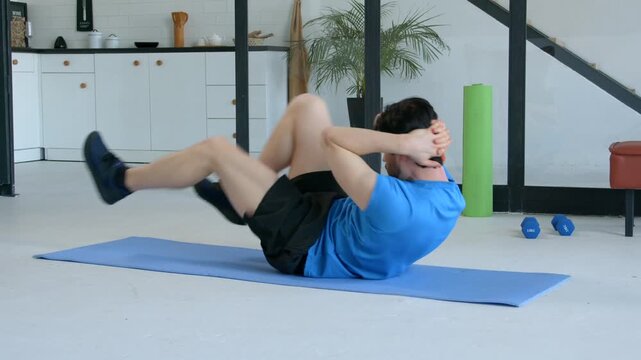 Motivated sporty fit senior man practicing bicycle crunches exercise on yoga mat, flexing and strengthening abdominal muscles and slimming waist during sports training at home.