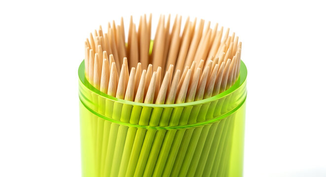 Close-up of numerous wooden toothpicks standing upright in a translucent green plastic holder, isolated on a white background, green container, dental hygiene