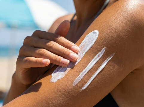 Woman applying white sunscreen lotion on bare skin of arm during relaxing summer day offering protective care against harsh sunlight ensuring healthy tan and preventing painful burn