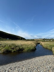 Fototapeta premium Coastal stream through grassy landscape in Ireland