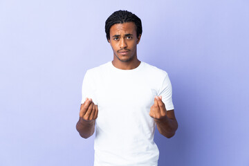Young African American man with braids man isolated on purple background making money gesture but is ruined