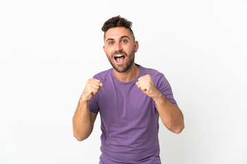 Fototapeta premium Caucasian man isolated on white background celebrating a victory in winner position