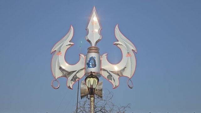 Close-up view of a large trishul (trident) with cobra symbol installed in Ayodhya, India. This powerful Hindu symbol represents Lord Shiva and divine energy, strength, and protection.
