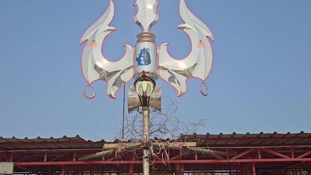 Close-up view of a large trishul (trident) with cobra symbol installed in Ayodhya, India. This powerful Hindu symbol represents Lord Shiva and divine energy, strength, and protection.