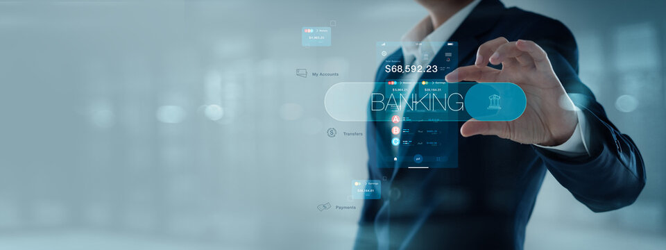 Businessman holding word banking in hand with dashboard of finance and online banking on digital network, online payment.