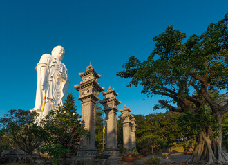 Standing Buddha statue against sky at Tong Lam Son Temple Nha Trang Vietnam