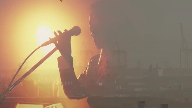 Musician playing keys, starting singing and reaching mic skyline overlaying silhouette performing