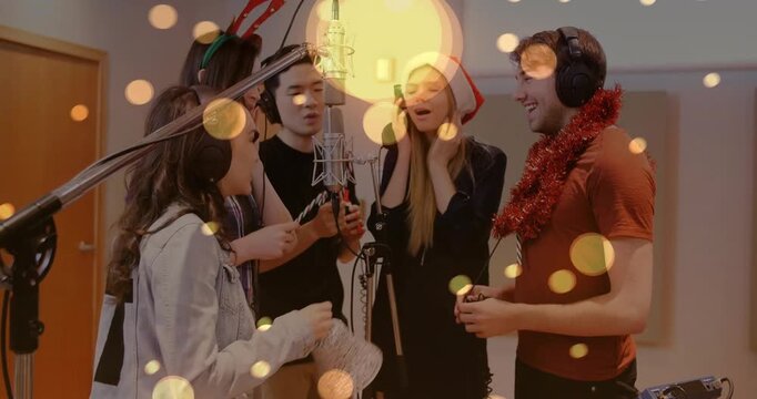 4 singers huddling around studio mic, lead holding phone starting holiday take, bokeh marking pitch