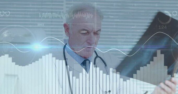 Senior doctor turning X-ray to light in clinic studying while animated graphs rising for diagnosis