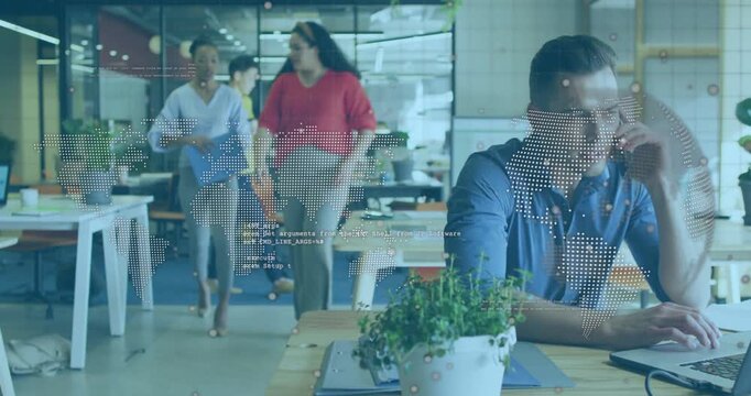 Vertical video: Man using phone, typing laptop as team entering with blue folder, business overlay